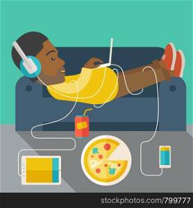 An african-american man in glasses and headphones lying on a sofa with electronic devices and fast food vector flat design illustration. Square layout.. Man lying on sofa.