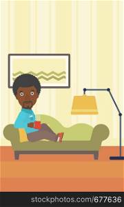 An african-american man lying on sofa in living room and holding a cup of hot flavored tea vector flat design illustration. Vertical layout.. Man lying with cup of tea.