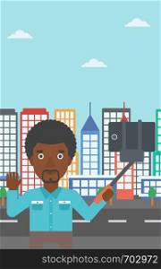 An african-american man making selfie with a selfie-stick. Man taking photo with cellphone and waving on a city background. Vector flat design illustration. Vertical layout.. Man making selfie vector illustration.