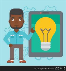 An african-american man pointing at a big tablet computer. Man standing near tablet computer with a light bulb on a screen. Vector flat design illustration. Square layout.. Man pointing at big tablet computer.