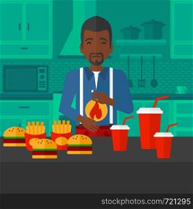 An african-american man standing in front of table full of junk food and suffering from heartburn on a kitchen background vector flat design illustration. Square layout.. Man suffering from heartburn.