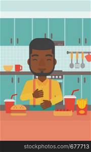An african-american man standing in the kitchen in front of table full of junk food and suffering from heartburn vector flat design illustration. Vertical layout.. Man suffering from heartburn.