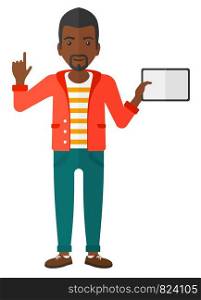 An african-american man standing with a tablet computer and pointing his forefinger up vector flat design illustration isolated on white background. . Man holding tablet computer.
