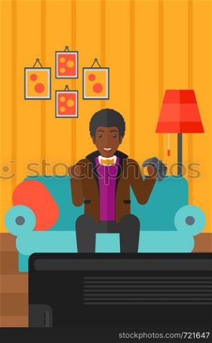 An african-american man with gamepad in hands sitting on a sofa in living room vector flat design illustration. Vertical layout.. Man playing video game.