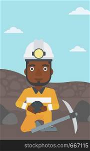 An african-american miner in hard hat sitting with coal in hands and a pickaxe on the background of coal mine. Vector flat design illustration. Vertical layout.. Miner holding coal in hands vector illustration.