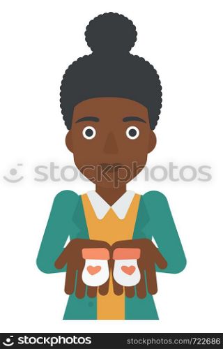 An african-american pregnant woman holding baby booties in hands vector flat design illustration isolated on white background. . Pregnant woman with baby booties.