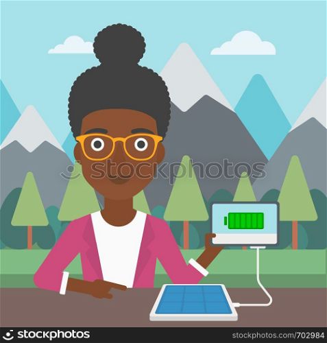 An african-american woman charging tablet computer with solar panel on a background of mountains. Charging digital tablet from portable solar panel. Vector flat design illustration. Square layout.. Solar panel charging tablet computer.