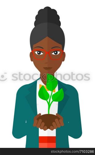 An african-american woman holding in hands a small plant in soil vector flat design illustration isolated on white background. . Woman holding plant.