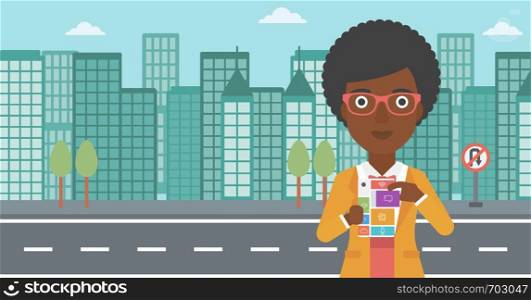 An african-american woman holding modular phone. Woman with modular phone standing on a city background. Woman using modular phone. Vector flat design illustration. Horizontal layout.. Woman with modular phone vector illustration.