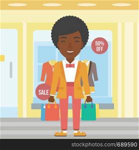 An african-american woman holding shopping bags on the background of boutique window with dressed mannequins. Happy young woman carrying shopping bags. Vector flat design illustration. Square layout.. Happy woman with bags vector illustration.