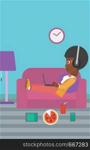 An african-american woman in headphones lying on a sofa in living room with electronic devices and fast food vector flat design illustration. Vertical layout.. Woman lying on sofa with many gadgets.