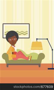 An african-american woman lying on sofa in living room and holding a cup of hot flavored tea vector flat design illustration. Vertical layout.. Woman lying with cup of tea.