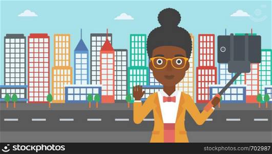 An african-american woman making selfie with a selfie-stick. An african-american woman taking photo with cellphone and waving on a city background. Vector flat design illustration. Horizontal layout.. Woman making selfie vector illustration.