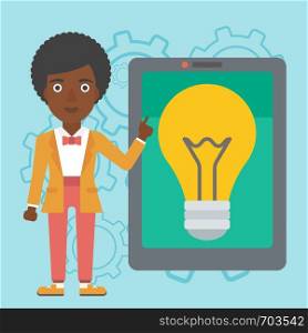 An african-american woman pointing at a big tablet computer. Woman standing near a big tablet computer with a light bulb on a screen. Vector flat design illustration. Square layout.. Woman pointing at big tablet computer.