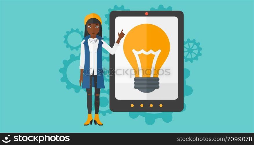 An african-american woman pointing at a big tablet computer with a light bulb on a screen on a blue background with cogwheels vector flat design illustration. Horizontal layout.. Woman pointing at tablet computer with light bulb on screen.