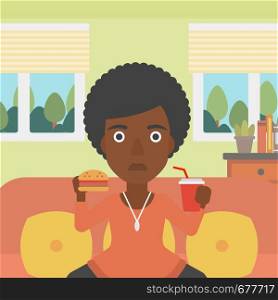 An african-american woman sitting on a sofa while eating hamburger and drinking soda on the background of living room vector flat design illustration. Square layout.. Woman eating hamburger.