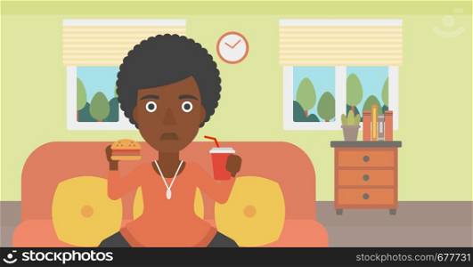 An african-american woman sitting on a sofa while eating hamburger and drinking soda on the background of living room vector flat design illustration. Horizontal layout.. Woman eating hamburger.