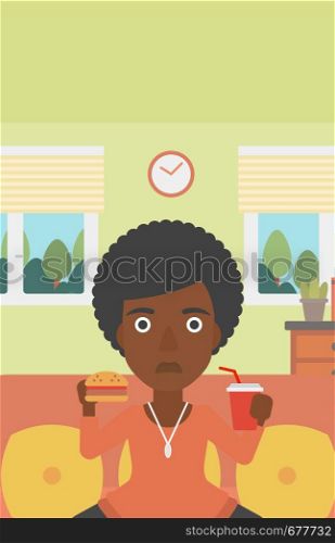 An african-american woman sitting on a sofa while eating hamburger and drinking soda on the background of living room vector flat design illustration. Vertical layout.. Woman eating hamburger.