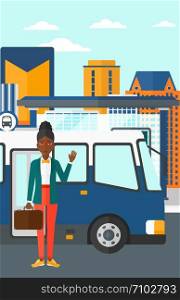 An african-american woman standing at the entrance door of bus on the background of bus stop with skyscrapers behind vector flat design illustration. Vertical layout.. Woman standing near bus.