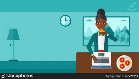 An african-american woman standing in room in front of a laptop while eating junk food vector flat design illustration. Horizontal layout.. Woman eating hamburger.