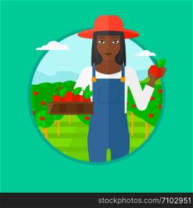 An african-american woman standing in the garden and holding a crate full of apples in hands. Female farmer collecting apples. Vector flat design illustration in the circle isolated on background.. Farmer collecting apples vector illustration.