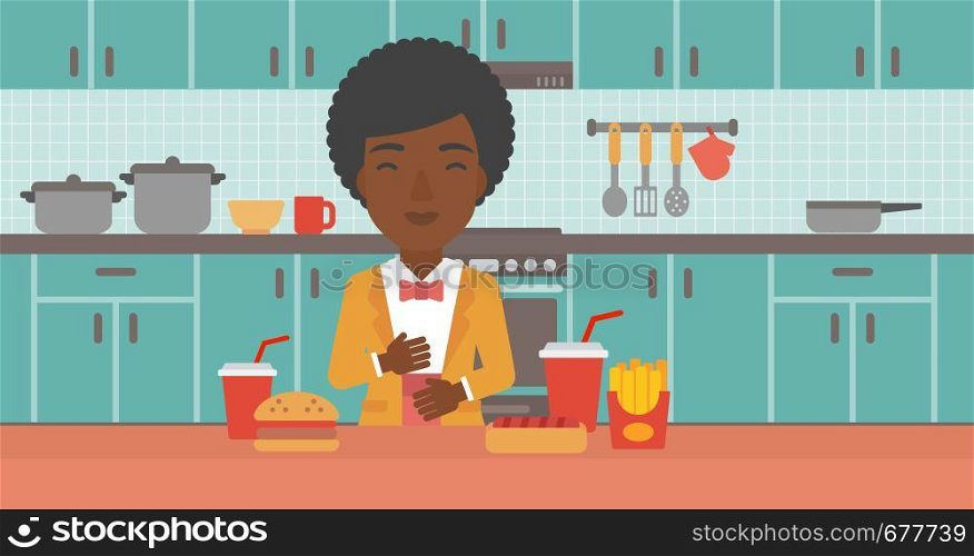 An african-american woman standing in the kitchen in front of table full of junk food and suffering from heartburn vector flat design illustration. Horizontal layout.. Woman suffering from heartburn.