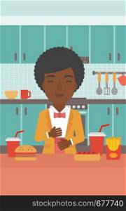 An african-american woman standing in the kitchen in front of table full of junk food and suffering from heartburn vector flat design illustration. Vertical layout.. Woman suffering from heartburn.