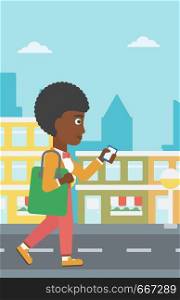 An african-american woman walking with a smartphone on a city background vector flat design illustration. Vertical layout.. Woman walking with smartphone.