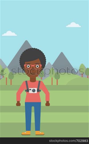 An african-american woman with a digital camera on her chest. Tourist with a digital camera standing on the background of mountains. Vector flat design illustration. Vertical layout.. Woman with camera on chest vector illustration.