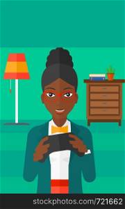 An african-american woman with gamepad in hands on a living room background vector flat design illustration. Vertical layout.. Woman playing video game.