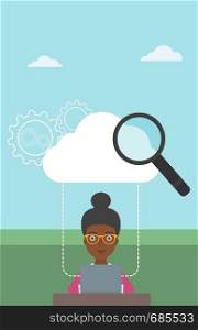 An african-american young business woman working on a laptop and cloud, magnifier and gears above her. Cloud computing concept. Vector flat design illustration. Vertical layout.. Cloud computing technology vector illustration.