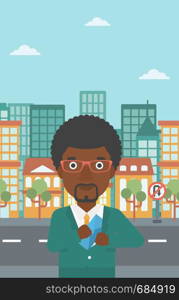 An african-american young businessman putting an envelope in his pocket on a city background. Vector flat design illustration. Vertical layout.. Man putting envelope in pocket vector illustration
