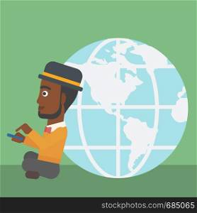 An african-american young businessman sitting near big Earth globe and holding a smartphone in hands. Concept of global business. Vector flat design illustration. Square layout.. Businessman sitting near Earth globe.