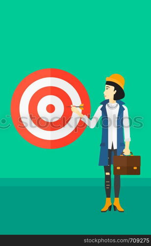 An asian business woman standing with arrow in hand and aiming at a target board on a green background vector flat design illustration. Vertical layout.. Business woman with target board.