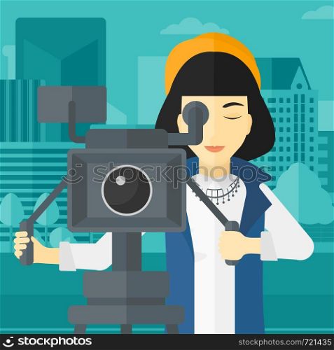 An asian camerawoman looking through movie camera on a city background vector flat design illustration. Square layout.. Camerawoman with movie camera on a tripod.