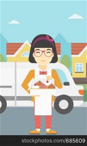 An asian female baker holding a box of cakes. A baker delivering cakes. Baker with cupcakes standing on the background of delivery truck. Vector flat design illustration. Vertical layout.. Baker delivering cakes vector illustration.