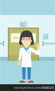 An asian female doctor in medical gown showing ok sign. Smiling doctor gesturing ok sign. Doctor with ok sign gesture in the hospital corridor. Vector flat design illustration. Vertical layout.. Doctor showing ok sign vector illustration.
