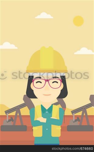 An asian female oil worker in uniform and helmet. An oil worker with crossed arms. An oil worker standing on a background of pump jack. Vector flat design illustration. Vertical layout.. Cnfident oil worker vector illustration.