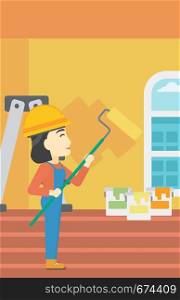 An asian female painter in overalls with a paint roller in hands. Painter painting walls with a paint roller in an apartment. Vector flat design illustration. Vertical layout.. Painter with paint roller.