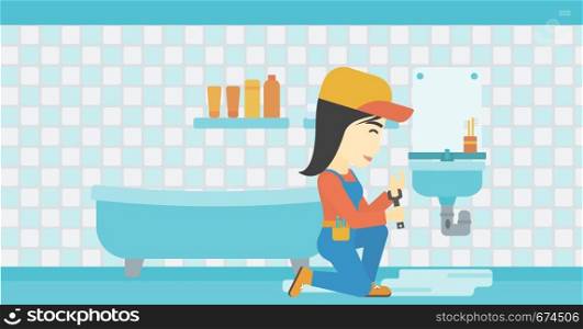 An asian female plumber sitting in a bathroom and repairing sink pipe. Plumber with wrench repairing a broken sink in bathroom. Horizontal layout.. Woman repairing sink.