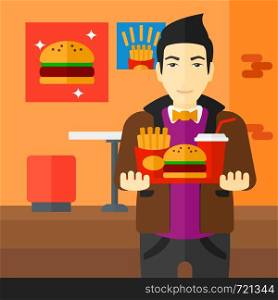 An asian man holding a tray full of junk food on a cafe background vector flat design illustration. Square layout.. Man with fast food.