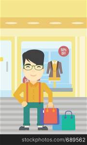 An asian man holding shopping bags on the background of boutique window with dressed mannequins. Happy young man carrying shopping bags. Vector flat design illustration. Vertical layout.. Happy man with shopping bags vector illustration.
