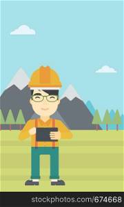 An asian man in hardhat holding a tablet computer in hands on the background of mountain landscape. Man working on digital tablet. Vector flat design illustration. Vertical layout.. Man holding tablet computer vector illustration.