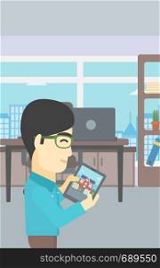 An asian man looking at house on a digital tablet screen. Young man standing in office and looking for house on tablet computer. Vector flat design illustration. Vertical layout.. Man looking for house vector illustration.
