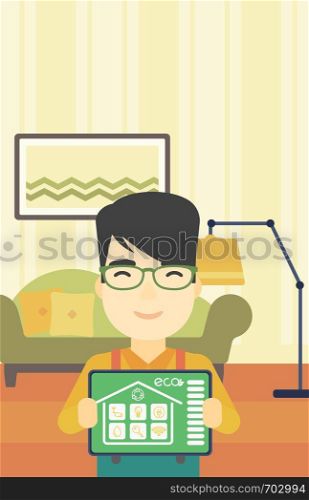 An asian man showing a tablet computer with smart home application on a screen on the background of living room. Vector flat design illustration. Vertical layout.. Smart home automation vector illustration.