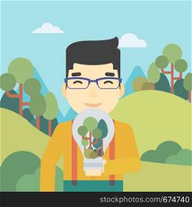 An asian man standing on the background of green forest and holding in hands a big lightbulb with trees inside. Green energy concept. Vector flat design illustration. Square layout.. Man with lightbulb and trees inside.
