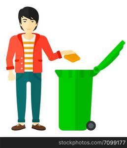 An asian man throwing a trash into a green bin vector flat design illustration isolated on white background. . Man throwing trash.