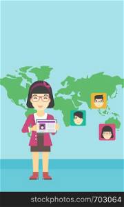 An asian woman holding tablet computer with social network user profile on a screen on a background of map with avatars of social network. Vector flat design illustration. Vertical layout.. Woman holding tablet with social network.