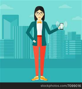 An asian woman holding vibrating smartphone on a city background vector flat design illustration. Square layout.. Woman holding ringing telephone.