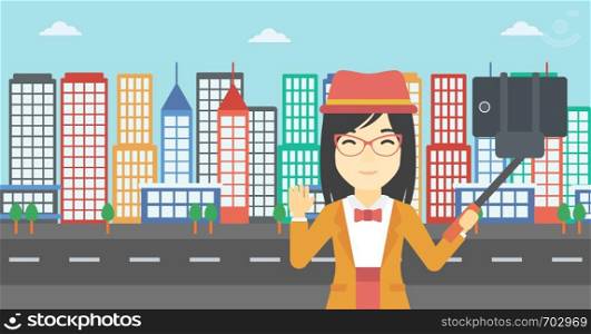 An asian woman making selfie with a selfie-stick. An asian woman taking photo with cellphone and waving on a city background. Vector flat design illustration. Horizontal layout.. Woman making selfie vector illustration.